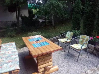 a wooden table and two chairs and a table and chairs at Sunny Paradise in Bihać