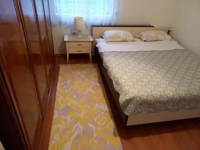a small bedroom with a bed and a night stand at Vacation Home 