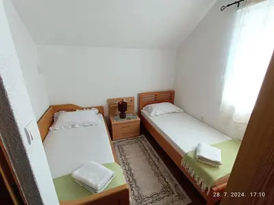 two beds in a small room with a window at Vacation Home 