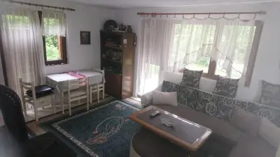 a living room with a couch and a table at Cottage Forest Stream in Visoko