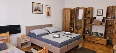 a bedroom with a bed and a tv in it at Trosoban stan u Zenici in Zenica