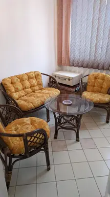a living room with chairs and a table and a couch at Trosoban stan u Zenici in Zenica
