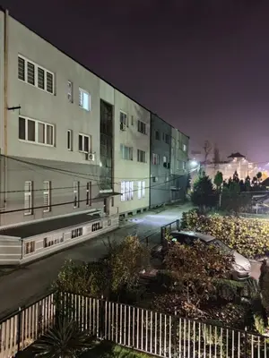 a view of a building at night at Trosoban stan u Zenici in Zenica