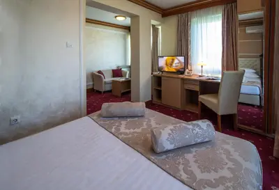 a hotel room with a bed and a desk at Hotel Cezar Banja Luka in Banja Luka