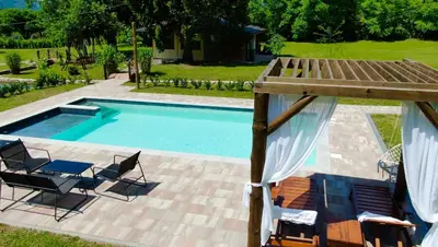 a swimming pool with a deck and chairs next to it at Vacation House Studenac in Bihać