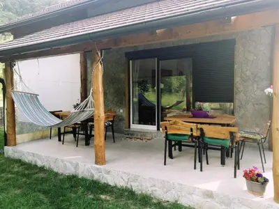 a patio with hammocks and a table and chairs at Vacation House Studenac in Bihać