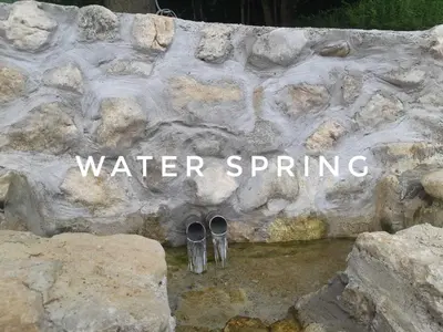 two pairs of shoes sitting on top of a stone wall at Vacation House Studenac in Bihać