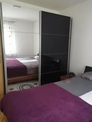 a bedroom with two beds and a mirrored cabinet at Vacation House Studenac in Bihać