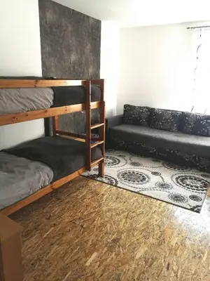 a room with two bunk beds and a couch at Vacation House Studenac in Bihać