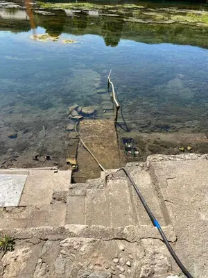 a hose is sticking out of the water at Villa Dino in Kulen Vakuf