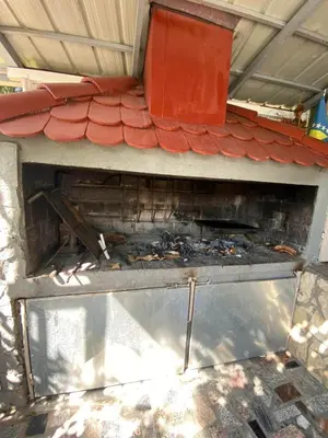 an outdoor grill with some food inside of it at Villa Dino in Kulen Vakuf