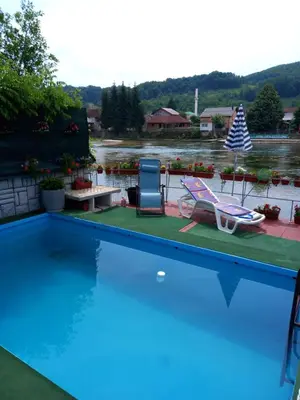 a swimming pool with a view of a body of water at Villa Dino in Kulen Vakuf