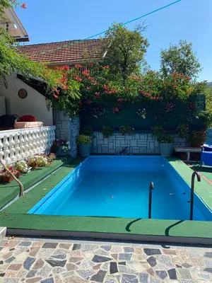 a swimming pool in the backyard of a house at Villa Dino in Kulen Vakuf
