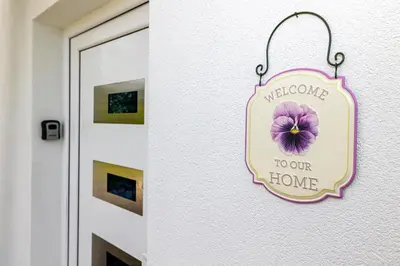 a sign that reads welcome to our home next to a door at simply-una in Bihać