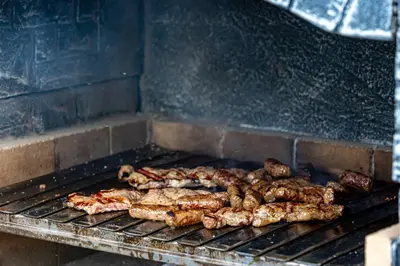 a bunch of food cooking on a grill at simply-una in Bihać