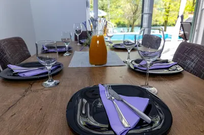 a wooden table with plates and wine glasses on it at simply-una in Bihać
