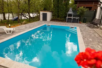 a swimming pool with blue water in a yard at simply-una in Bihać