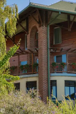 a brick building with potted plants on the balconies at Hotel Athos in Modriča