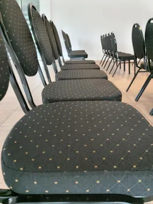 a row of chairs lined up in a room at Hotel Athos in Modriča