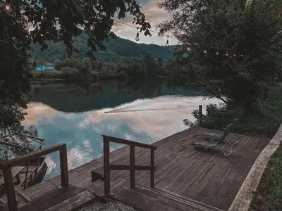 a wooden dock with a view of a lake at Holiday home Green coast in Bosanska Krupa
