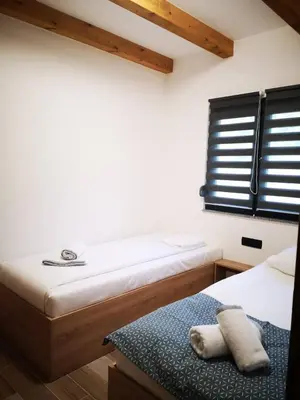 a bedroom with two beds and a window at Holiday home Green coast in Bosanska Krupa