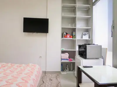 a bedroom with a bed and a tv on a wall at Soba Centar in Banja Luka