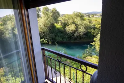 a view of a river from a balcony at Apartments and Rooms Villa Majestic in Bihać