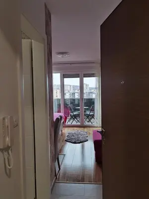 a hallway with a door open to a room with a balcony at Apartman Krasula Doboj in Doboj