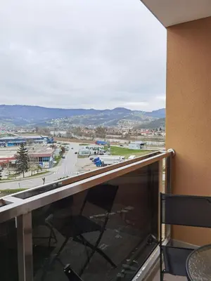a balcony with a view of a parking lot at Apartman Krasula Doboj in Doboj