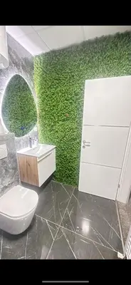 a bathroom with a white toilet and a green wall at Gradiska Pristajko in Bosanska Gradiška