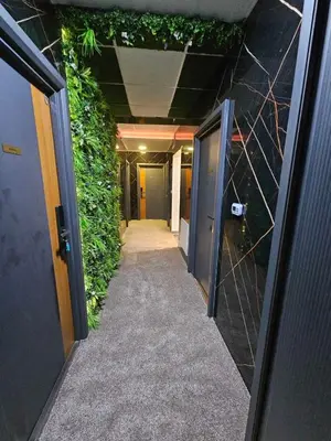 a hallway of an office building with a green wall at Gradiska Pristajko in Bosanska Gradiška