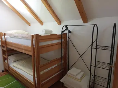 a room with bunk beds in a attic at Holiday Home Dzeni in Zenica