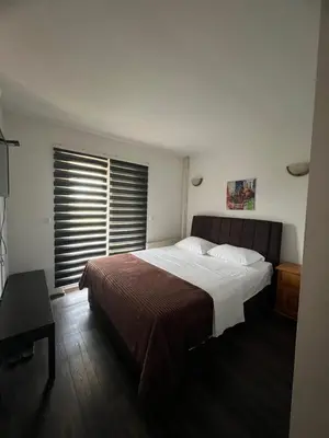 a bedroom with a large bed and a window at Prenoćište SAMIR in Gradačac