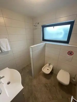 a bathroom with a toilet and a sink and a window at Villa My Island in Bihać