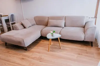 a living room with a couch and a table at Studio Apartment Dzungla in Doboj