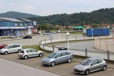 a group of three cars parked in a parking lot at Studio Apartment Dzungla in Doboj