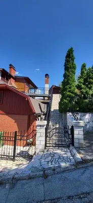 a house with a fence and stairs in front of it at Mott Residence in Tuzla