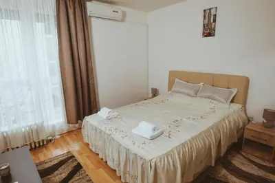 a bedroom with a bed with two towels on it at Apartman CENTAR 1 in Banja Luka