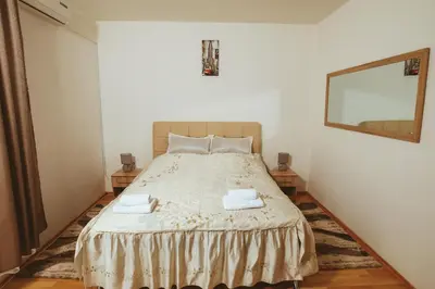 a bedroom with a large bed with a mirror at Apartman CENTAR 1 in Banja Luka