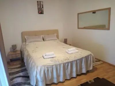 a bedroom with a bed with two towels on it at Apartman CENTAR 1 in Banja Luka