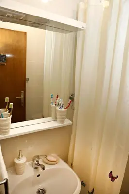 a bathroom with a sink and a mirror at Merak Holiday Home in Visoko