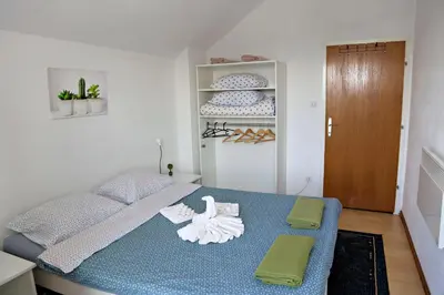 a bedroom with a bed with towels on it at Merak Holiday Home in Visoko
