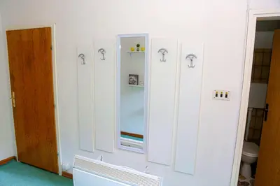 a room with white cabinets and a mirror at Merak Holiday Home in Visoko