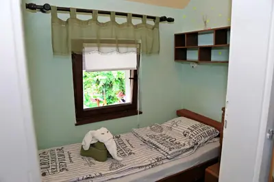 a small bedroom with a bed and a window at Merak Holiday Home in Visoko