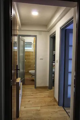 a hallway with a bathroom with a toilet and a mirror at Apartman Srdjan in Banja Luka