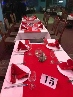 a long table with red napkins and glasses on it at Motel HEKO in Bugojno