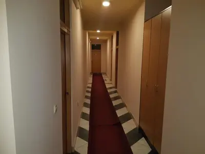 a long hallway with a long red corridor at Motel HEKO in Bugojno