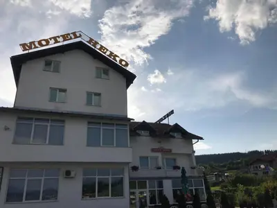 a hotel with a sign on the top of it at Motel HEKO in Bugojno
