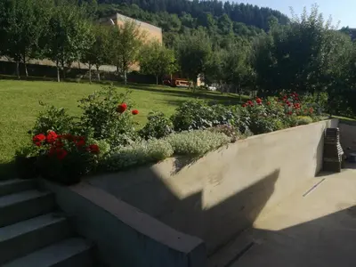 a retaining wall with flowers in a park at Edo in Visoko