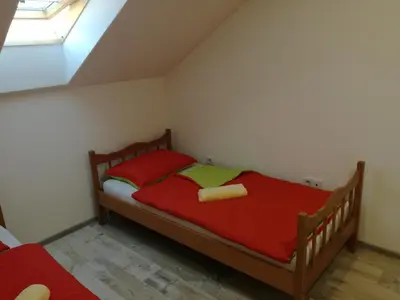 a bedroom with a bed with red sheets and a window at Edo in Visoko